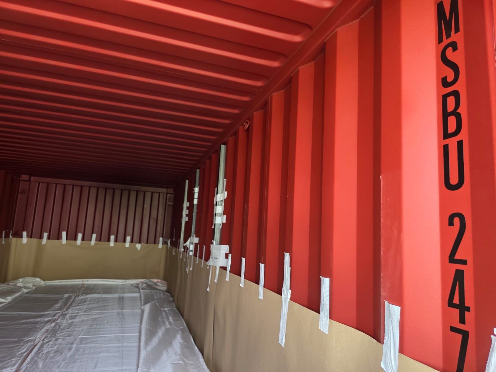 Interior of a maritime container being lined and prepared for flexitank installation
