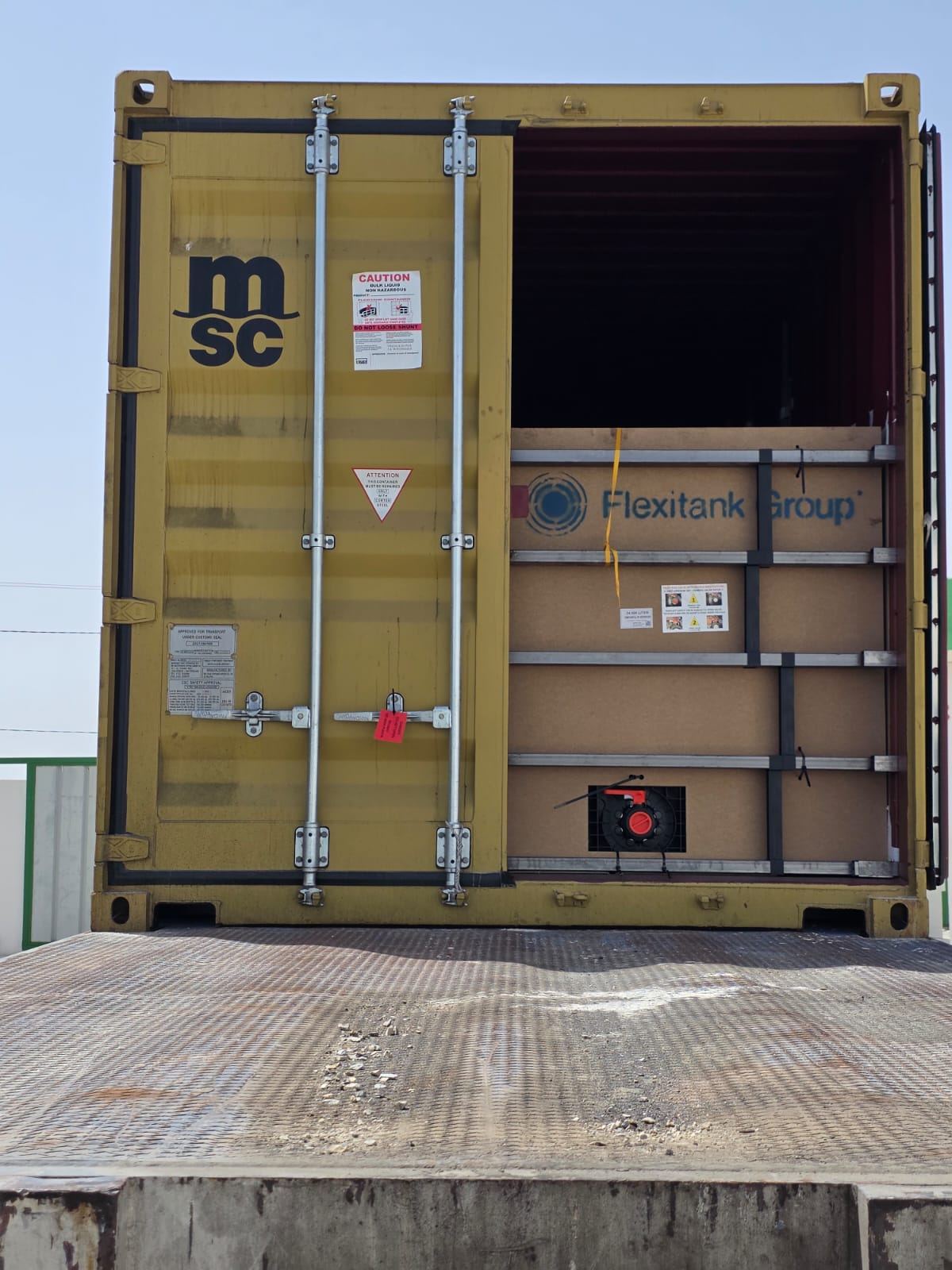 Flexitank Group installation and outlet assembly visible inside a shipping container
