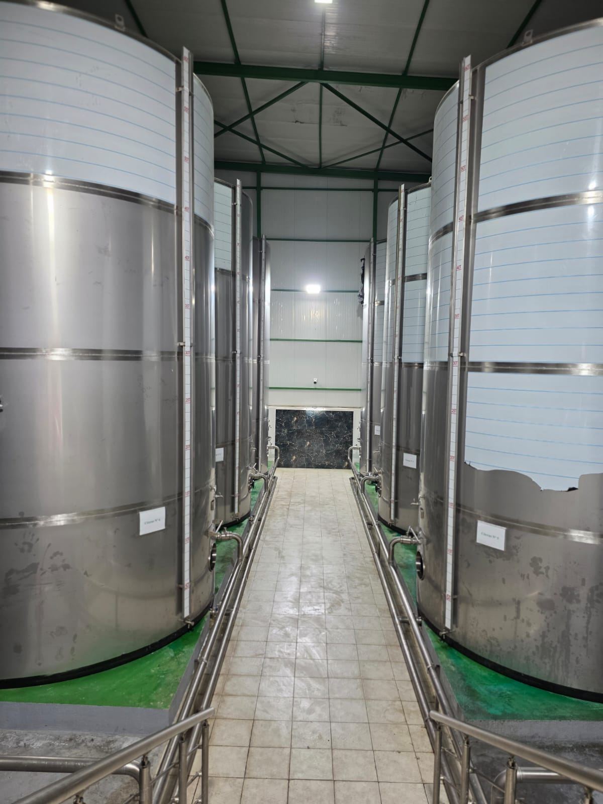 Interior view of AGRO OLEA storage installations with metallic tanks and fixed piping
